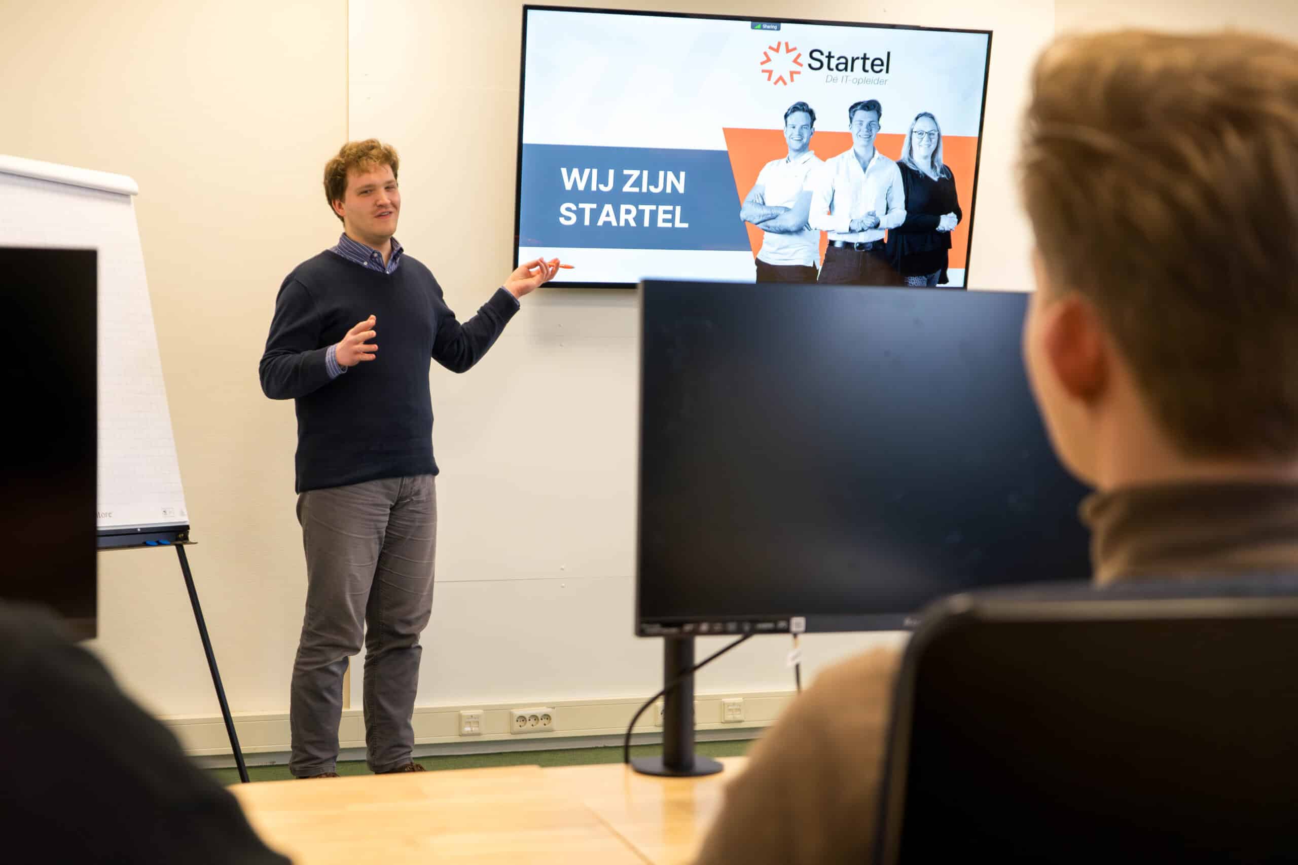 Een medewerker van Startel (Johannes van Oosterom) staat voor de klas.